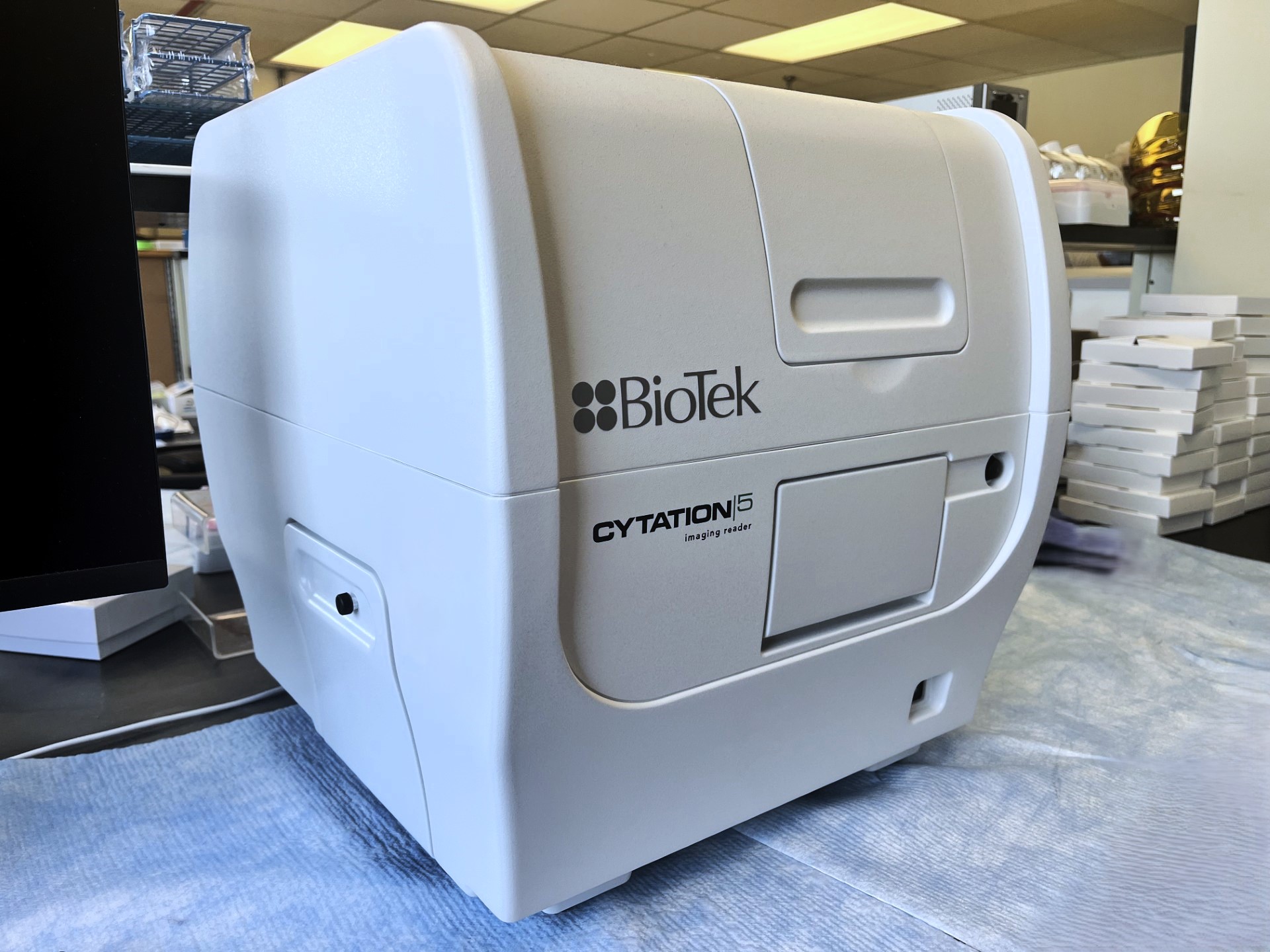 A boxy object sits atop a desk that appears too large for an actual lab. Was it Generative AI? Or...perhaps something devious...